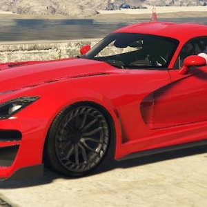 Può includere: Un'auto sportiva rosso brillante con cerchi neri. L'auto ha un design elegante e aerodinamico, con prese d'aria visibili e una linea del tetto curva. È parcheggiata su una superficie di cemento vicino all'acqua.