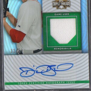 May include: A baseball card featuring Daniel Bard, a Boston Red Sox player, with a green background and a white jersey patch. The card is numbered 31/50 and includes a blue autograph. The card text reads "Daniel Bard, Boston Red Sox, 2010, Team Fireman of Year, Topps Triple Threads, Game-Used, Memorabilia, Topps Certified Autograph Issue."