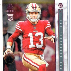 Tarjeta de fútbol BROCK PURDY RC 2022 Panini Chronicles Luminance #213 Pink Parallel - San Francisco 49ers