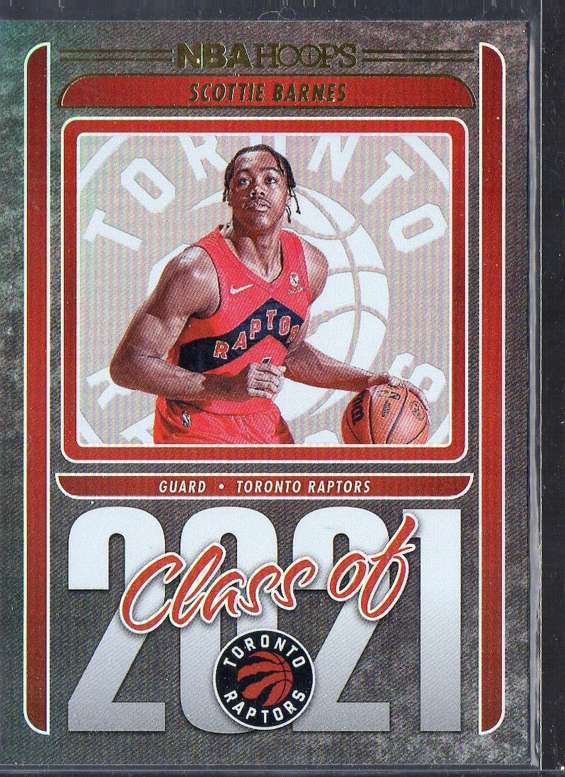 May include: A basketball trading card featuring Scottie Barnes, a guard for the Toronto Raptors. The card is part of the NBA Hoops Class of 2021 series. The card features a photo of Barnes in his Raptors uniform, with the team logo and the text "Class of 2021" on the card.
