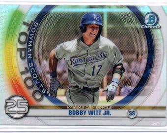 May include: A baseball card featuring a baseball player wearing a blue and white baseball uniform with the text "Kansas City" and the number "17" on the front. The card is part of the Bowman Scouts Top 100 series and features the player Bobby Witt Jr. The card is a chrome card.