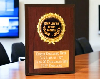 May include: A wooden plaque with a gold Employee of the Month award. The plaque has a space for custom engraving with up to 3-4 lines of text, up to 20 characters per line. Free engraving is offered.