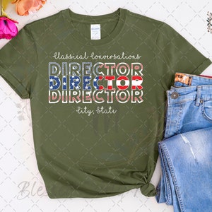 May include: A green t-shirt with the text "Classical Conversations Director" in white with red, white, and blue stripes. The text "City, State" is below the main text.