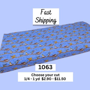 May include: Blue fabric with a repeating pattern of birds perched on brown branches. The fabric has a light blue background with small white dots. The text "Fast Shipping" is in the upper left corner. The number "1063" is in the center.