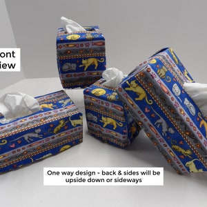 May include: Four blue and gray tissue box covers with a cat and fish pattern. The covers are made of fabric and have a one-way design, meaning the back and sides will be upside down or sideways.
