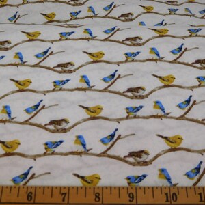 May include: Fabric with a repeating pattern of birds perched on brown branches against a white background. The birds are yellow, blue, and brown. The branches are horizontal and evenly spaced. The fabric is suitable for quilting or other craft projects.
