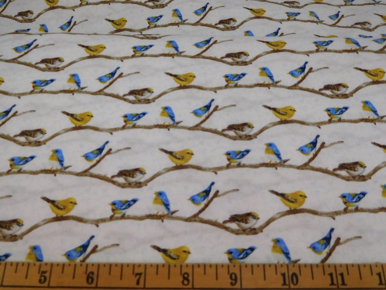 May include: Fabric with a repeating pattern of birds perched on brown branches against a white background. The birds are yellow, blue, and brown. The branches are horizontal and evenly spaced. The fabric is suitable for quilting or other craft projects.