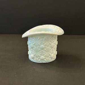 May include: A white milk glass hat shaped vase with a diamond pattern.