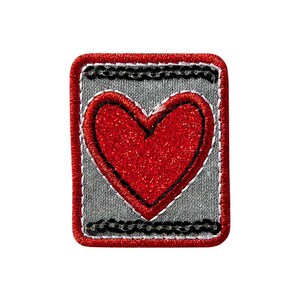 Op de afbeelding: Rode glitterhart geborduurd op een grijze stoffen patch met een zwarte en rode rand.