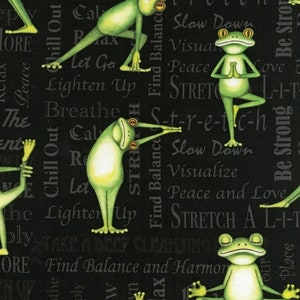 May include: Black fabric with a repeating pattern of green frogs doing yoga poses. The fabric has text that reads "Chill Out", "Breathe", "Lighten Up", "Find Balance", "Stretch", "Slow Down", "Visualize", "Peace and Love", "Be Strong", "Take a Deep Cleansing", "Find Balance and Harmony".