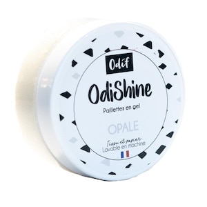 Puede incluir: Un recipiente blanco con un patrón geométrico en blanco y negro. El recipiente está etiquetado con "OdiShine" y "Paillettes en gel" en texto negro. El recipiente también tiene la palabra "OPALE" en texto negro. El recipiente está etiquetado con "Tissu et papier" y "Lavable en machine" en texto negro. El recipiente tiene una bandera francesa en él.