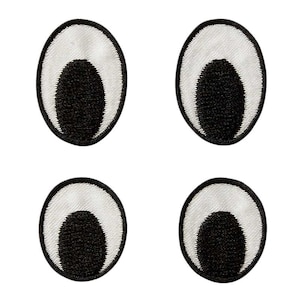 Op de afbeelding: Vier zwarte en witte oogjes met een witte buitenring, een zwarte binnenring en een witte kern.