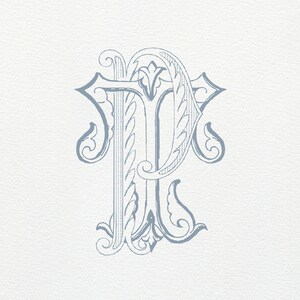 May include: A decorative monogram initial "P" in a blue-grey color. The letter is stylized with intricate flourishes and swirls.