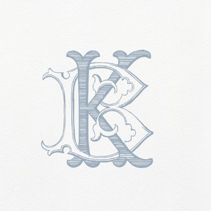 May include: A blue and white monogram initial "K" with a decorative, ornate design.