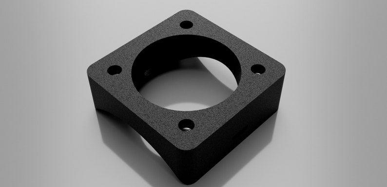 May include: Black square-shaped metal adapter with four holes and a round opening in the center.