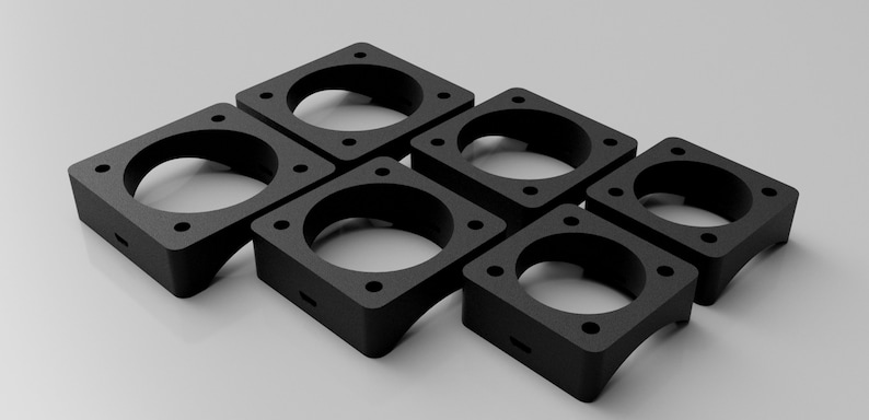 May include: Six black plastic fan mounts with square bases and circular openings. The mounts are designed to hold fans in place.