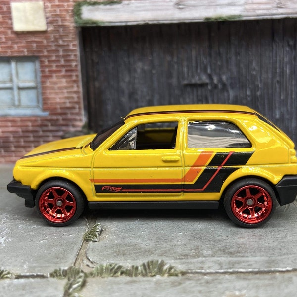 Custom Hot Wheels VW Volkswagen Golf MK2 In Yellow, Black and Orange With Red 6 Spoke Studded Wheels and Rubber Tires