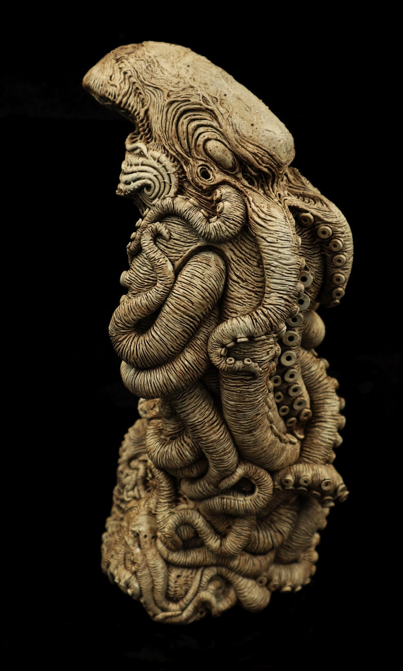 May include: A detailed ceramic sculpture of an octopus with a textured surface and intricate details. The sculpture is painted in shades of brown and beige.