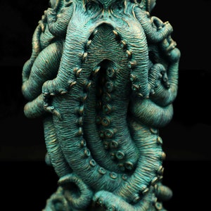 May include: A teal green octopus sculpture with detailed tentacles and a textured surface.
