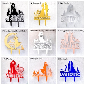 May include: A collection of nine acrylic wedding cake toppers in various colors including black, gold, silver, rose gold, red, orange, and blue. Each topper features silhouettes of couples and pets with personalized surnames and dates in script or block text.