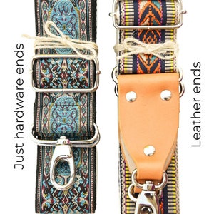 May include: Two camera straps with different end styles. One strap has a silver metal clasp and the other has a brown leather end. Both straps have a colorful woven pattern.