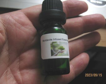 Moldavite infused essential musk oil ,10ml with a genuine moldavite inside