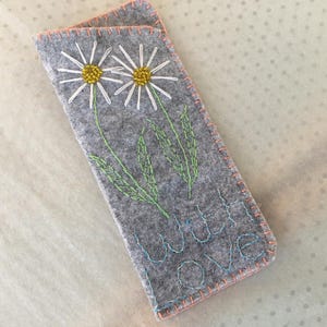 Hand embroidered felt glasses case.