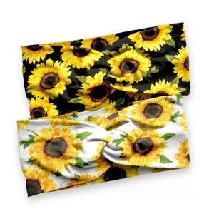 May include: Two sunflower patterned headbands. One headband is black with white sunflowers and the other is white with black sunflowers.