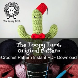 May include: Crochet pattern for a green cactus amigurumi wearing a red fez hat and a red bow tie. The pattern is available as an instant PDF download. The image shows the finished cactus amigurumi, yarn, and a crochet hook.