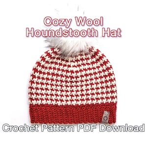 May include: Red and white crocheted hat with a houndstooth pattern and a white pom pom on top. The hat has a red crocheted brim. The text "Cozy Wool Houndstooth Hat Crochet Pattern PDF Download" is at the bottom of the image.