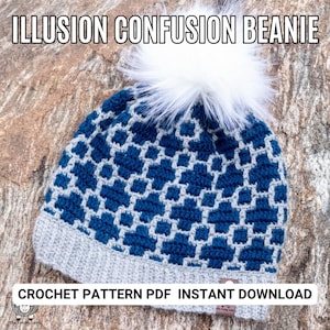 May include: A crochet beanie pattern featuring a blue and gray geometric design. The beanie has a white pom pom on top. The pattern is available as an instant download PDF. "ILLUSION CONFUSION BEANIE" and "CROCHET PATTERN PDF INSTANT DOWNLOAD" are written on the image.