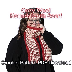 May include: A man wearing a gray sweater, blue jeans, and a red and white crocheted scarf. He is smiling and looking to the right.