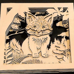May include: A layered wooden art piece featuring a smiling fox in a forest scene. The fox is light-colored, with detailed fur and facial features. The background includes trees, mountains, and foliage, all cut from wood, creating a 3D effect.