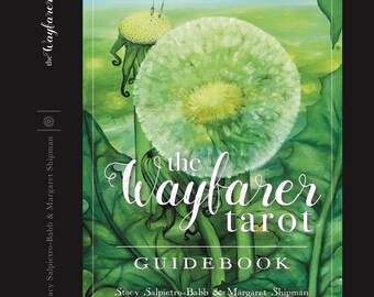 May include: The Wayfarer Tarot deck and guidebook set. The cover features a dandelion illustration in shades of green and white, with the title "The Wayfarer Tarot" in elegant script. The guidebook is included.
