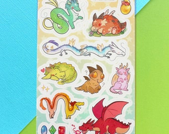 May include: A sticker sheet featuring various cartoon dragons in shades of green, orange, pink, yellow, and red. The dragons have different poses and expressions, with some having wings or breathing fire. The sheet has a light yellow background with star shapes.