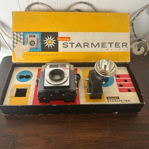 May include: A set of three ceramic vases in varying heights and shapes. The vases are glazed in a matte white finish, offering a minimalist aesthetic. The tallest vase is approximately 10 inches high.