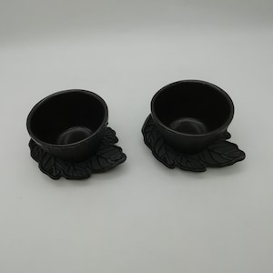 Set of two cast iron cups and saucers