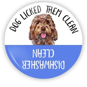 May include: A blue and white round sticker with the text "Dog licked them clean" and "Dishwasher clean" with a brown dog illustration in the center.