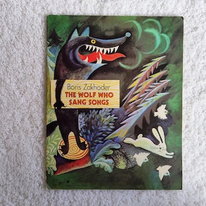 May include: A vintage children's book cover featuring a black wolf with an open mouth, red tongue, and white teeth. The title reads "THE WOLF WHO SANG SONGS" by Boris Zakhoder. The background is green with illustrations of a rabbit and birds.