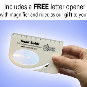 May include: White plastic letter opener with a built-in magnifying glass and ruler. The ruler is marked in inches from 1 to 10. The letter opener has the text "Snail Sakk" and "The "snail mail" catcher for mail slots!" printed on it. The text "www.snailsakk.com" is also printed on the letter opener.