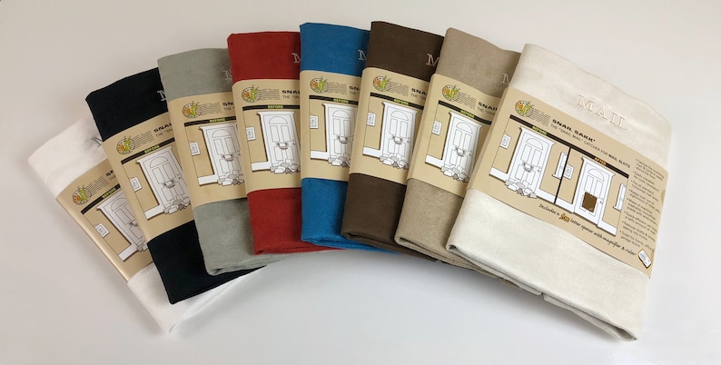 May include: A set of eight door draft stoppers in various colors, including white, black, gray, red, blue, brown, beige, and cream. The stoppers are made of fabric and have a simple design with the words "Draft Saver" and "The Door That Catches for Mini Drafts" printed on the label.