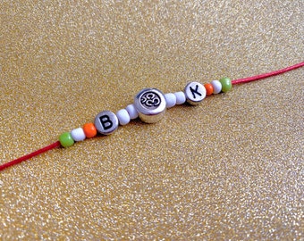 Aum Rakhi with Initial – Personalised Om Rakhi Bracelet – Handmade Raksha Bandhan Gift – Custom Red Thread Rakhi for Brother - unique gift