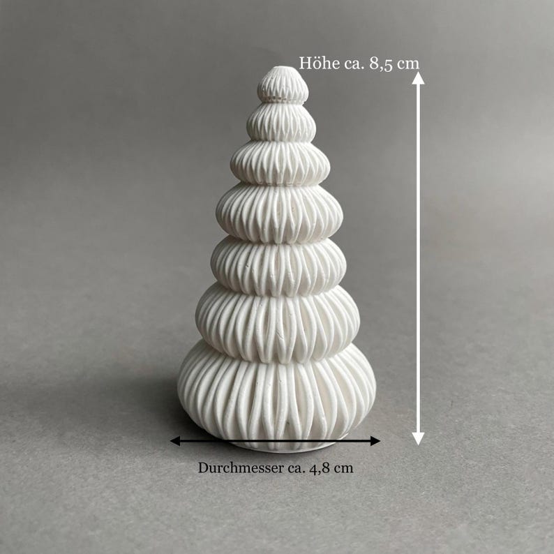 Puede incluir: Adorno de &aacute;rbol de Navidad de cer&aacute;mica blanca con un dise&ntilde;o acanalado. El adorno mide 8,5 cm de alto y 4,8 cm de di&aacute;metro. "H&ouml;he ca. 8,5 cm" y "Durchmesser ca. 4,8 cm" est&aacute;n escritos en alem&aacute;n en la imagen.