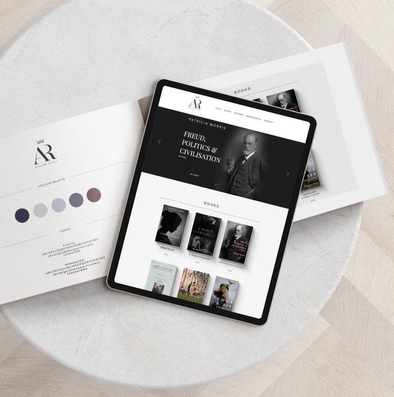 May include: A website design mockup on a tablet showing a website for a book publisher. The website features a black and white photo of Sigmund Freud and the text "Freud, Politics & Civilisation". The website also features a grid of book covers.