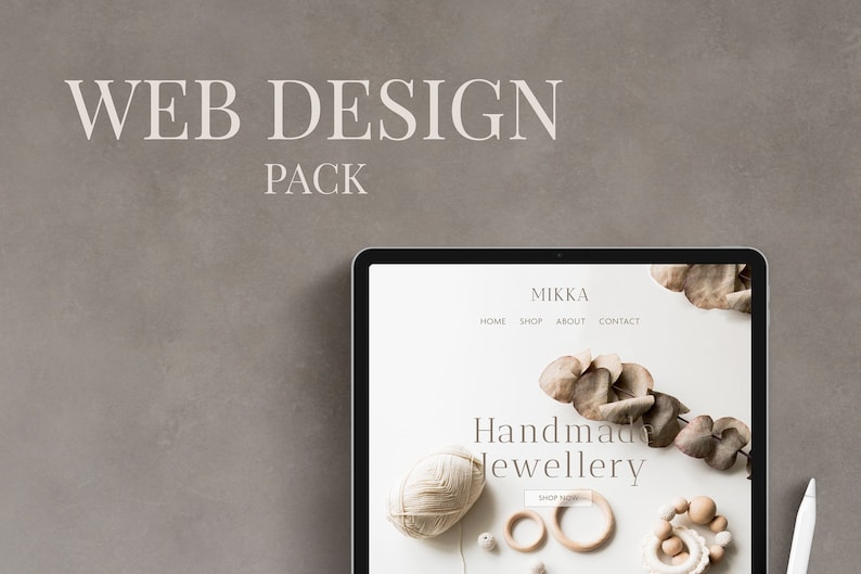 May include: A laptop screen displaying a website for Mikka Handmade Jewellery. The website features a white background with a light brown and white color scheme. The website text reads "Mikka Handmade Jewellery" and "Shop Now". The website also features a navigation bar with the following links: Home, Shop, About, Contact.