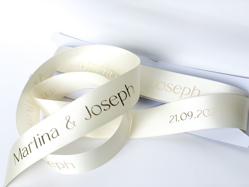 Cream satin ribbon with gold letter printed