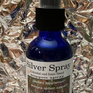 May include: A blue glass bottle with a black spray top and a white label that reads "Silver Spray Colloidal and Ionic blend 50ppm spray * Dietary Supplement* Immune system support* 2 fluid ounces 60ml".