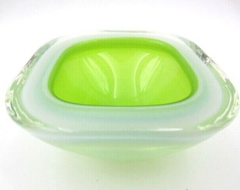 May include: A square, green glass dish with a white rim. The dish is made of clear glass with a green interior and a white rim.