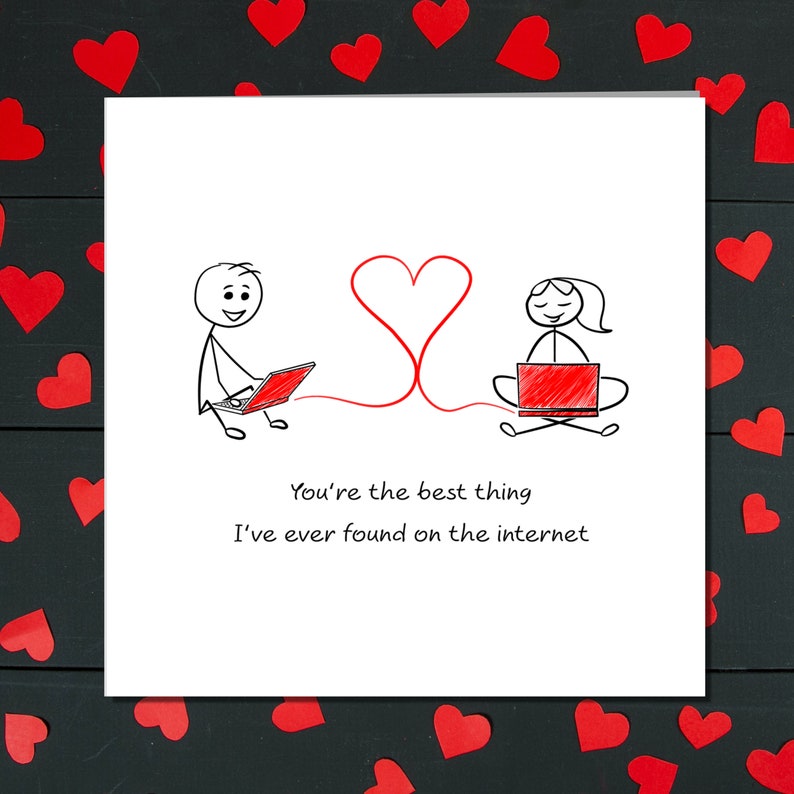 May include: A white card with a red heart drawn on it. Two stick figures are drawn on the card, each using a laptop. The text on the card reads "You're the best thing I've ever found on the internet."