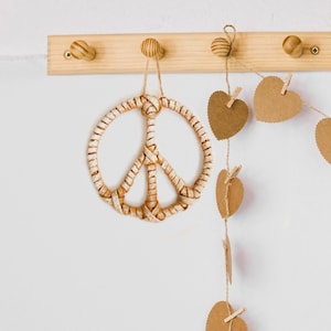 Rattan peace sign wall hanging for boho nursery decor